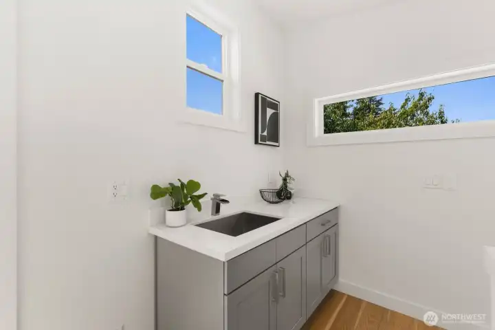 Third-floor wet bar with counter space and abundant natural light. Third-floor wet bar with counter space and abundant natural light.