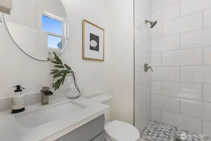 Third-floor bath with a walk-in tiled shower. Third-floor bath with a walk-in tiled shower.