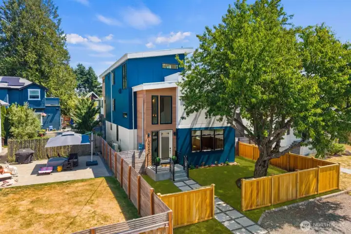 Elevated view highlighting the home’s modern architecture and generous yard. Elevated view highlighting the home’s modern architecture and generous yard.