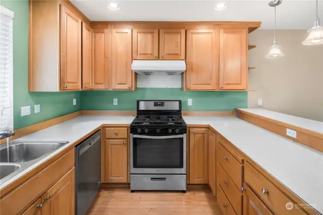 Cozy and practical kitchen with a gas range, dishwasher, and plenty of counter space for all your cooking needs.