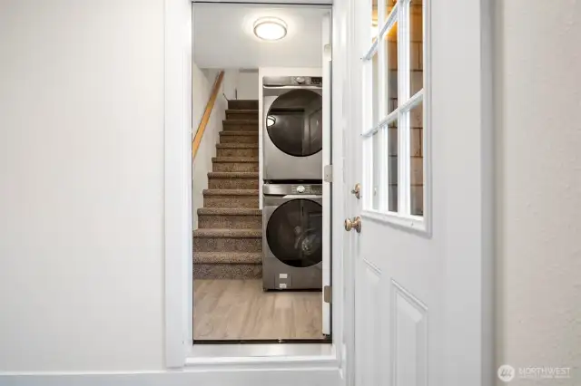 A view from the mudroom into the house, with the stairs to the finished attic space.