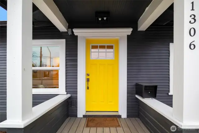 The covered porch and sunny front door welcome you inside.