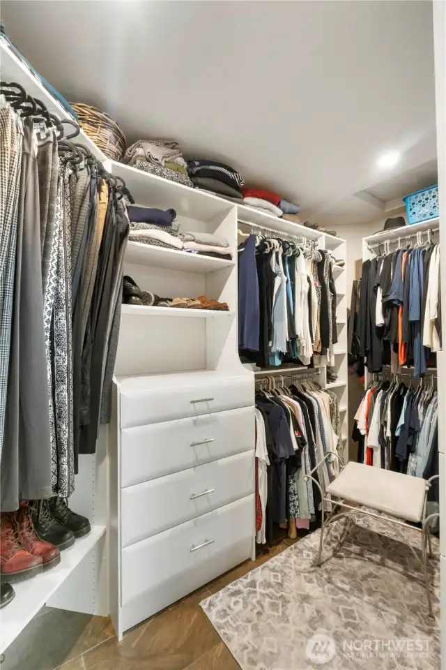 Primary Walk-in Closet – Well-organized custom built-ins with ample storage, drawers, and hanging space.