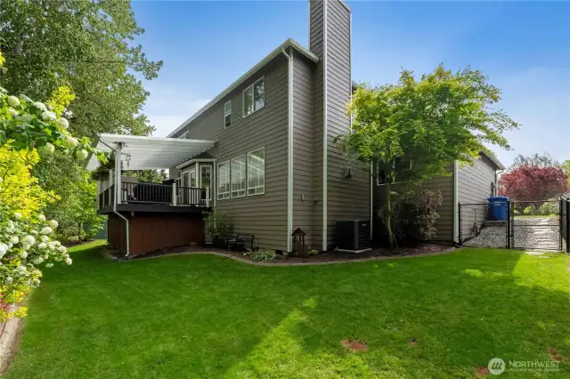 Gardener's delight. Manicured, fenced, and filled with color—this backyard’s got beauty and breathing room.