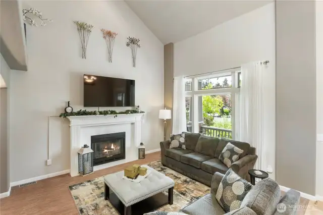 Get cozy, but make it classy. This welcoming living room with a stunning fireplace and vaulted ceilings brings warmth and style to your daily unwind.