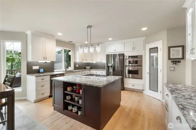 Chef vibes, engage. Entertain with ease in this gourmet kitchen featuring a granite-topped island, induction cooktop, and sparkling pendant lighting.