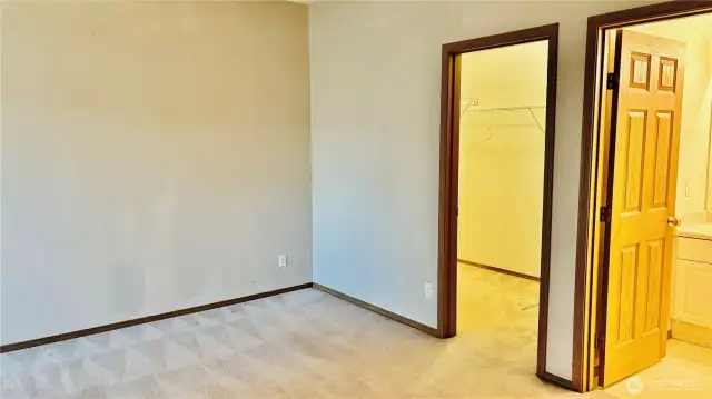 Primary bedroom looking into closet & bathroom