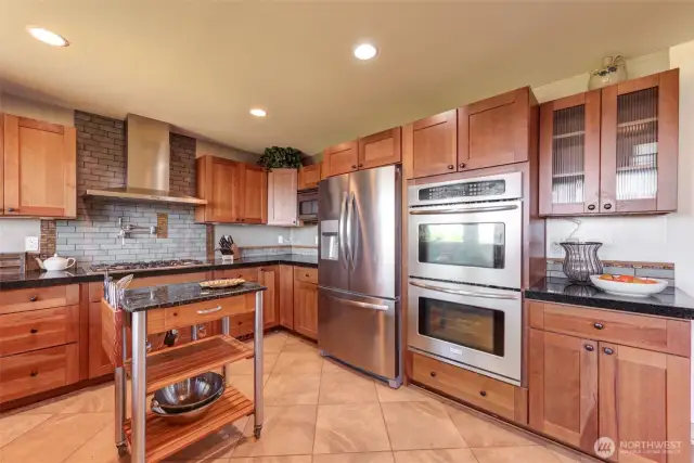 This well equipped kitchen offers a 5 burner gas range, pot filler, and double ovens!