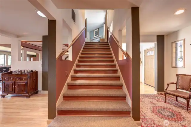 Glamorous wide staircase leading to the upstairs primary bedroom!