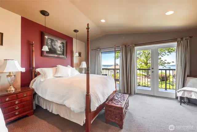 Large primary bedroom features vaulted ceilings, French doors, & a private deck!