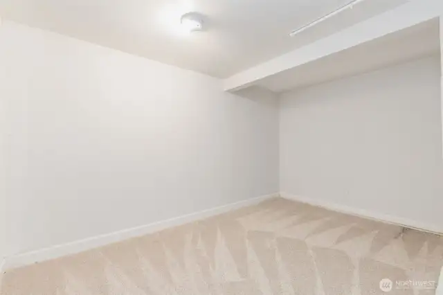 Primary basement room for gatherings, workout equipment, hobbies or storage.