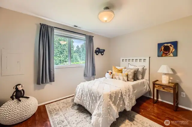 Second bedroom with lots of light, storage and hardwood floors.