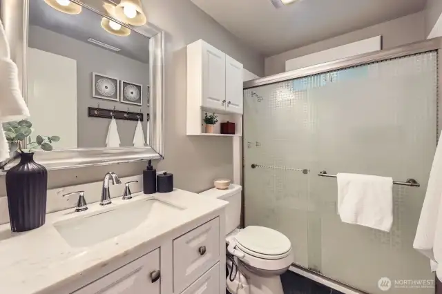Updated bathroom complete with quartz countertops, lots of storage, tile floors and a bidet.