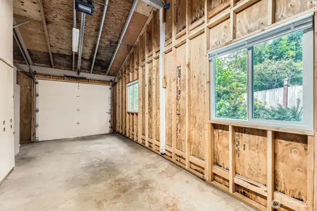 A spacious garage with a garage door opener