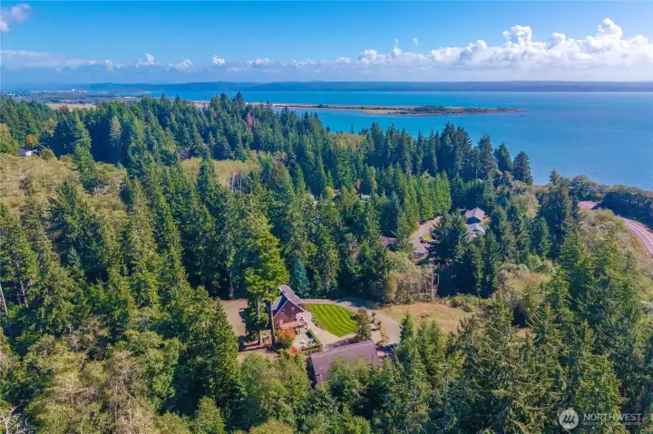 A gorgeous aerial of the home's estate size setting and the ocean bay beyond.