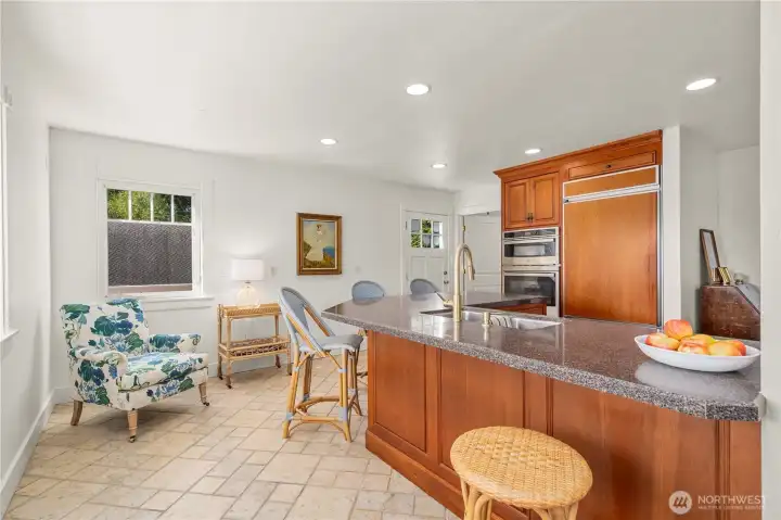 The kitchen boasts a generous island, subzero refrigerator & butler's pantry with wonderful stone tile flooring.