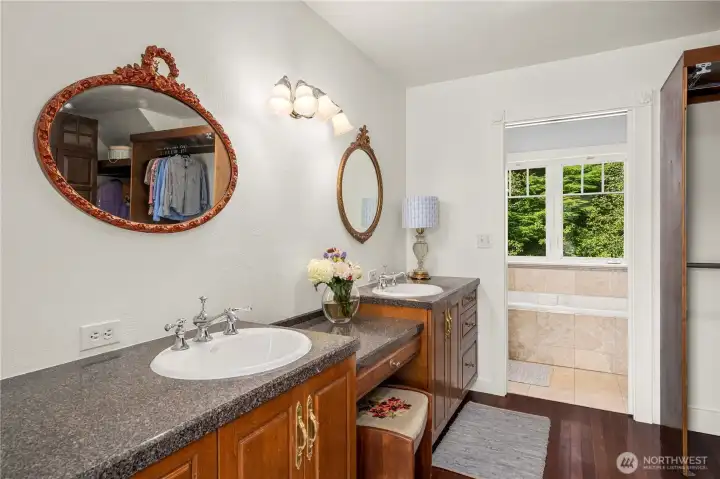 The charming sweet primary bath features dual sink space and cabinetry were custom designed by the owners.