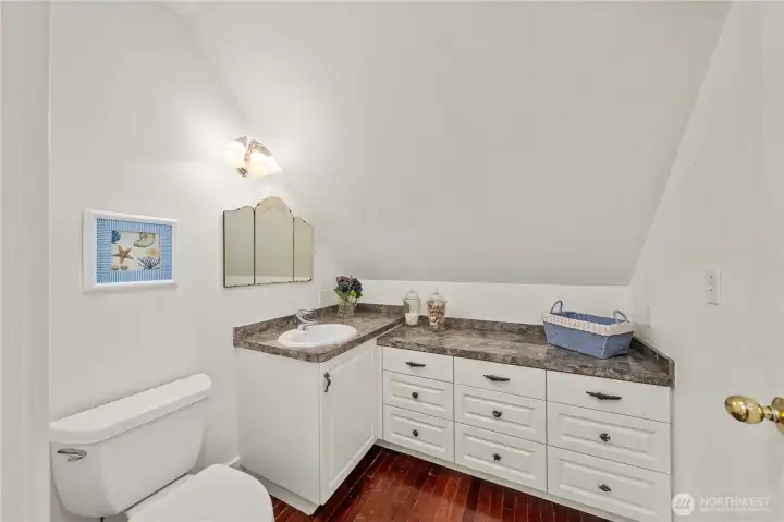 The 2nd floor upstairs bath brings seashells, with custom seashell tile work in the shower, a favorite of the owners.