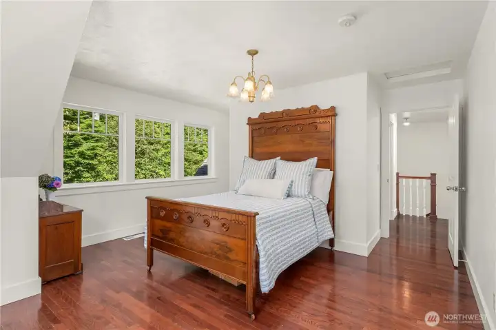 An additional upstairs bedroom, could be a den, offers plenty of charm with the same dark wood floors, dormer windows and dark wood flooring found throughout the home. There is a alcove for a dressing space, if needed.