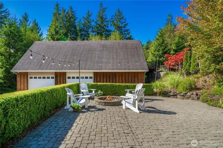 Also great for entertaining setting amongst the sound of a waterfall with garden steps from the main home and from the french doors of the lower level brings another view of the outside fire pit gathering. The owners have held a family wedding reception at the home making the string lights perfect.