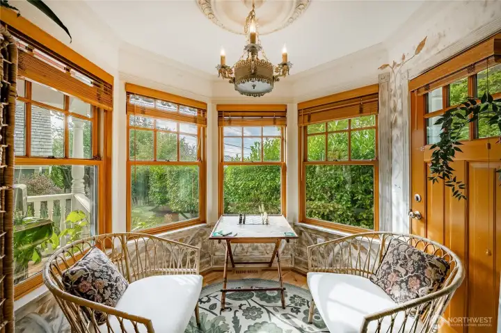 Sitting room directly off the kitchen can be used for dining area as well. Door leads out to the wrap around covered deck leading all the way to the front door.