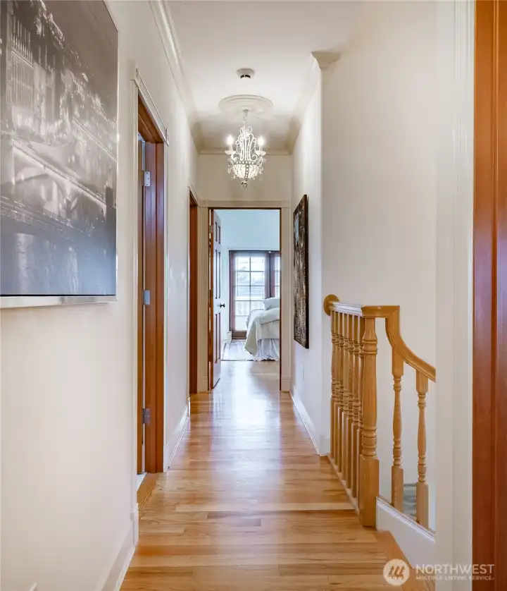 Photo taken from the 2 upstairs bedrooms. First door on the left is the full bathroom. Second door on the left is the Laundry Room. and at the end is the upstairs Primary Suite.