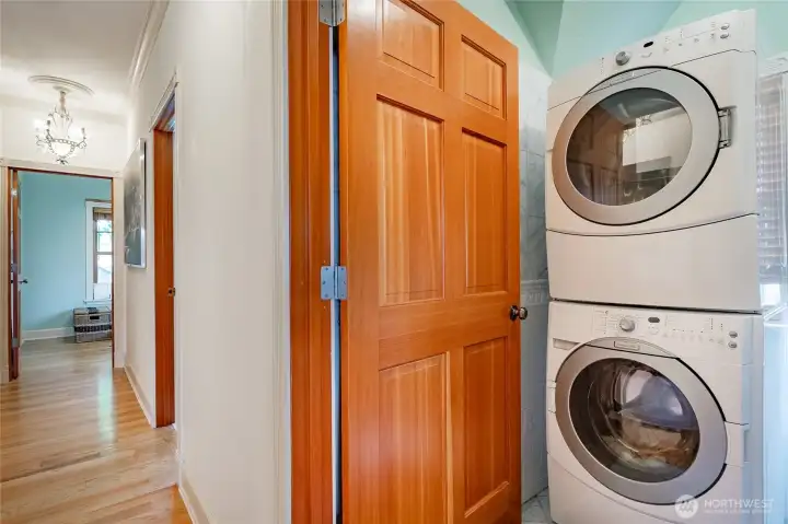 Laundry room. Looking back toward bedrooms 1&2. Stairs to the left and primary suite behind.
