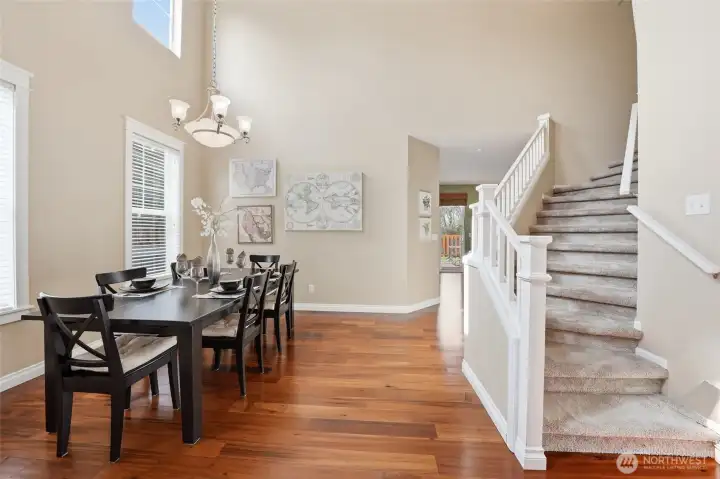 The rooms flow from the formal dining, to the grand stairs and into the open kitchen and living room.