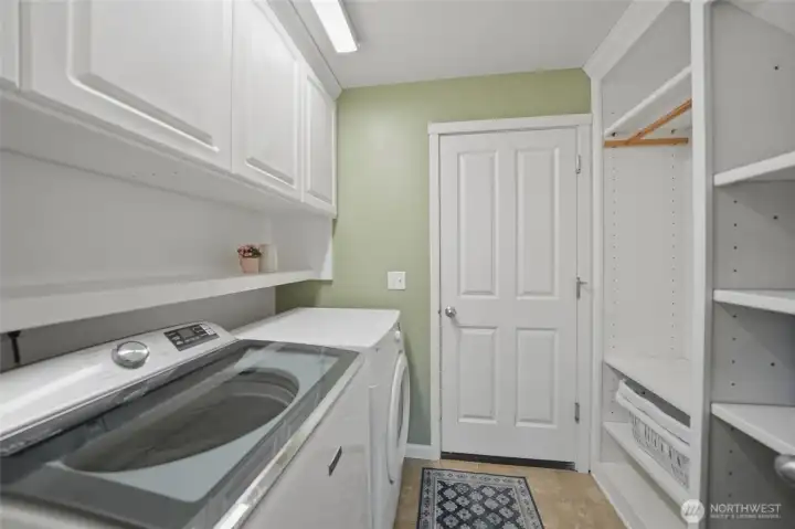 Main level laundry and mud room with built in shelves
