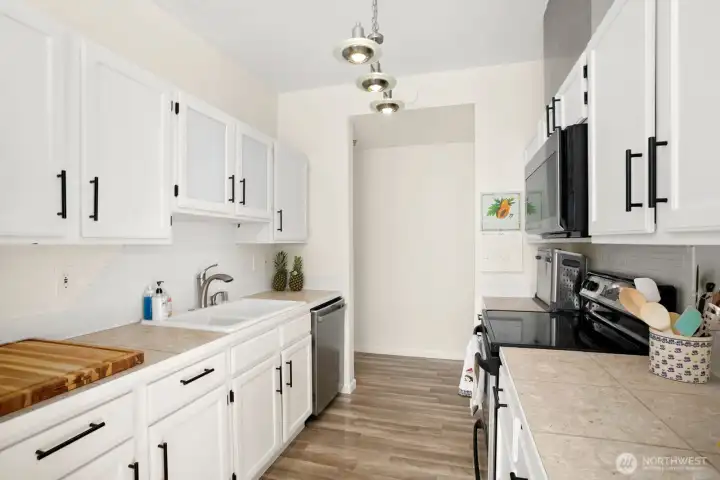 Galley-style kitchen with upper and lower cabinetry