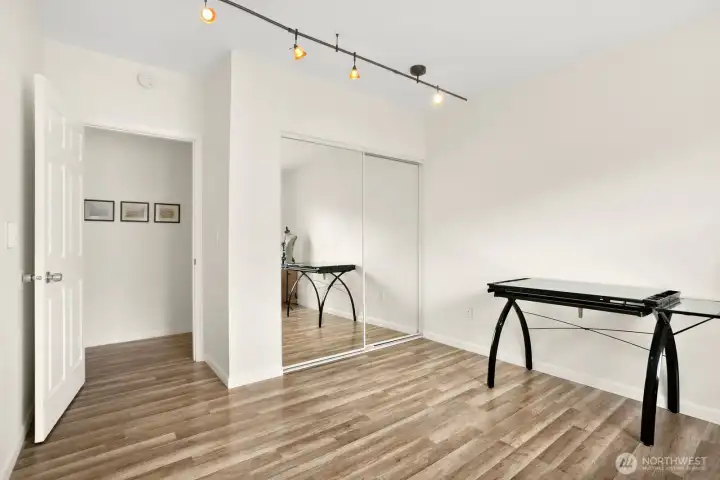 Bedroom 2 with mirrored closet and overhead lighting