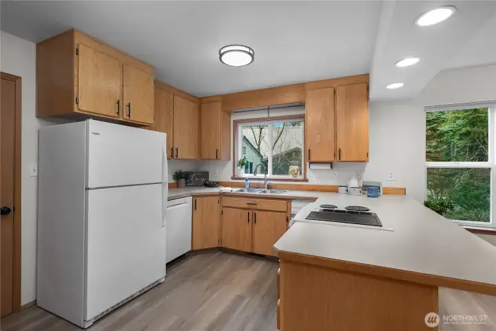 Kitchen with solid wood cabinetry. Bar seating. Kitchen with solid wood cabinetry. Bar seating.