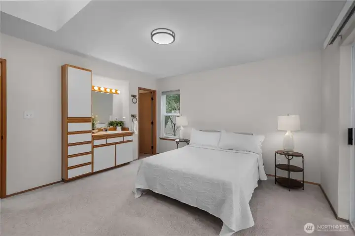 Primary bedroom with vanity. Ensuite 3/4 bathroom through door on the right. Primary bedroom with vanity. Ensuite 3/4 bathroom through door on the right.