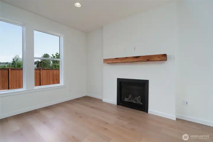 Great room with gas fireplace and wood mantle.  Pics are of a different 2601 Hattie plan home. Features and colors may differ.