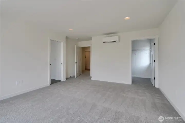 Upstairs primary bedroom. One of the two walk-in closets shown. Other is located inside of primary bathroom -  Pics are of a different 2601 Hattie plan home. Features and colors may differ.