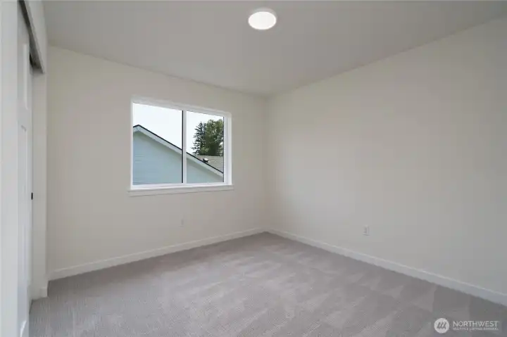 Second upstairs bedroom -  Pics are of a different 2601 Hattie plan home. Features and colors may differ.