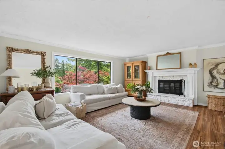 Spacious living room with functional wood fireplace.