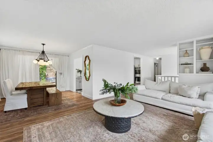 Living room area with built ins, dinning room and slider to the back yard.
