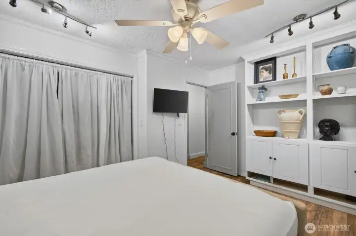 larger bedroom with built in cabinets.