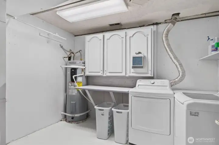 laundry room with washer and dryer.  AO Smith water heater is brand new.