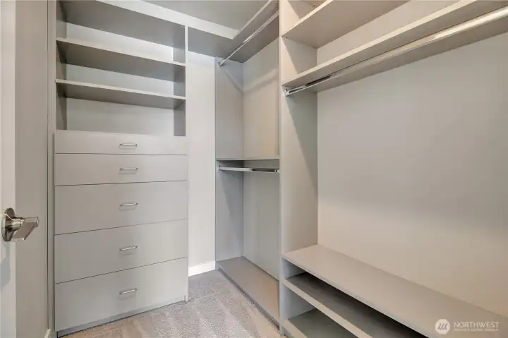 Primary closet with built in organizers. . .