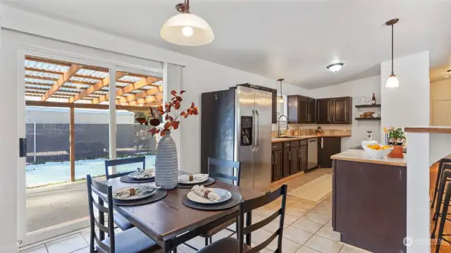 Kitchen has a quaint dining space with direct access to the covered back patio for easy indoor outdoor living.