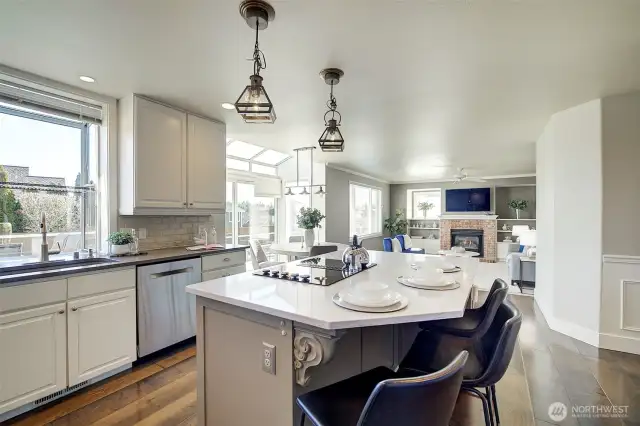 The kitchen features a large island with bar stool seating and a pantry closet.