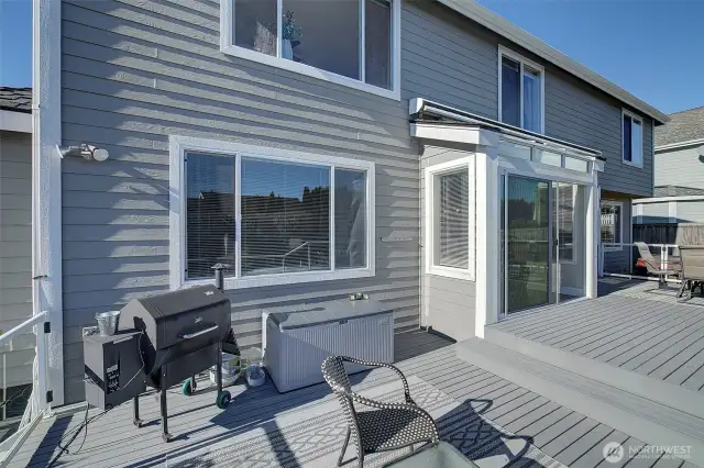 In addition to the wrap around patio, a full width deck offers additional opportunities for BBQ's and al fresco dining!  An awning, above the slider and the kitchen window, can be extended by remote.