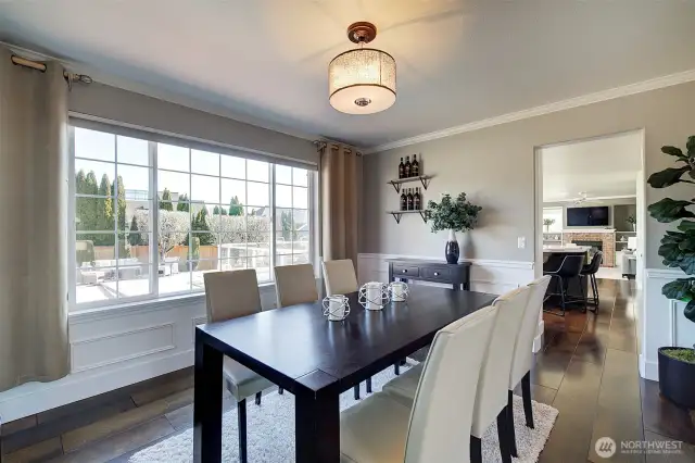 The generously sized dining room overlooks the backyard and is nicely accented with wainscoting and crown molding