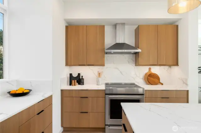 Induction range. Hood vents to the outside.  Photos are staged model of same floorplan.  Color schemes may vary.