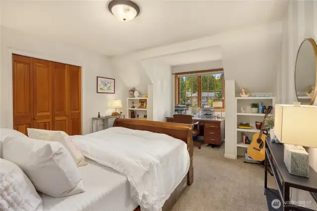 The second bedroom is also very spacious and features a beautiful dormer which is flanked by built-in shelf units.