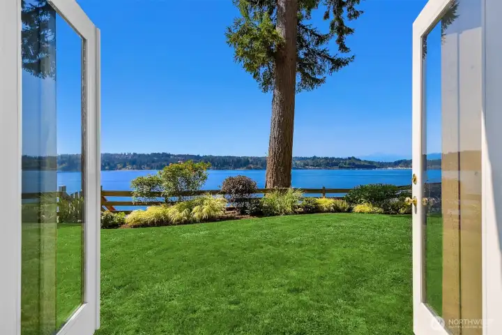French doors from the living room allow you to step out into your oasis to enjoy the sounds of the water lapping at the shore and watch the eagles fly overheard.