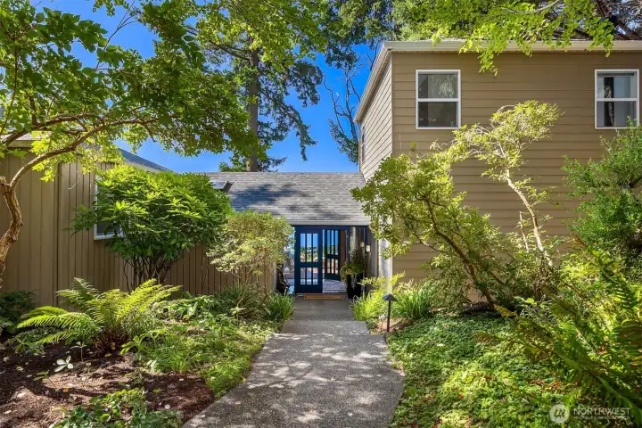 The path surrounded by lush gardens welcomes you home.