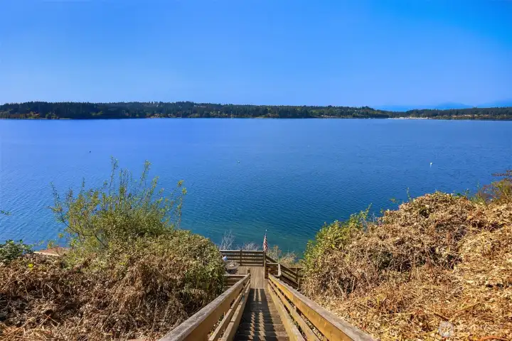 Sturdy stairs to the beach with a sitting platform half way down.